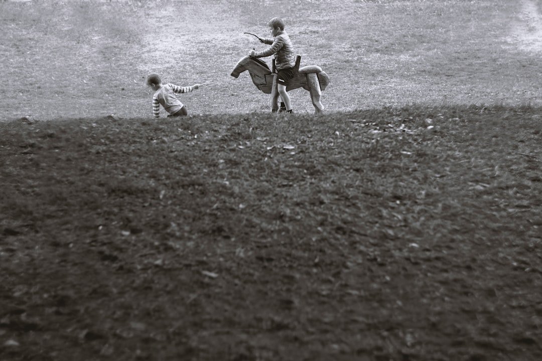 Female jockey racing thoroughbred horse at full gallop on dirt track